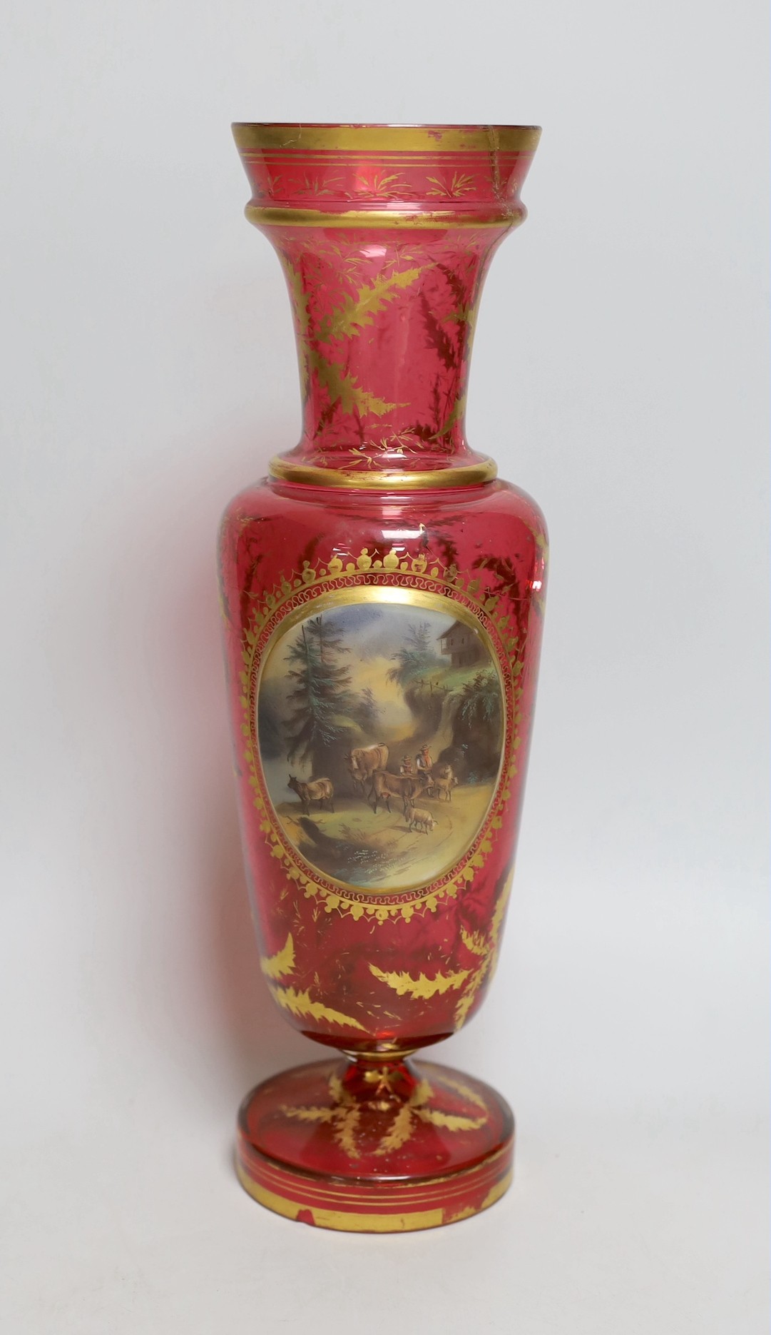 A 19th century Bohemian overlaid cranberry glass vase, 37cm tall